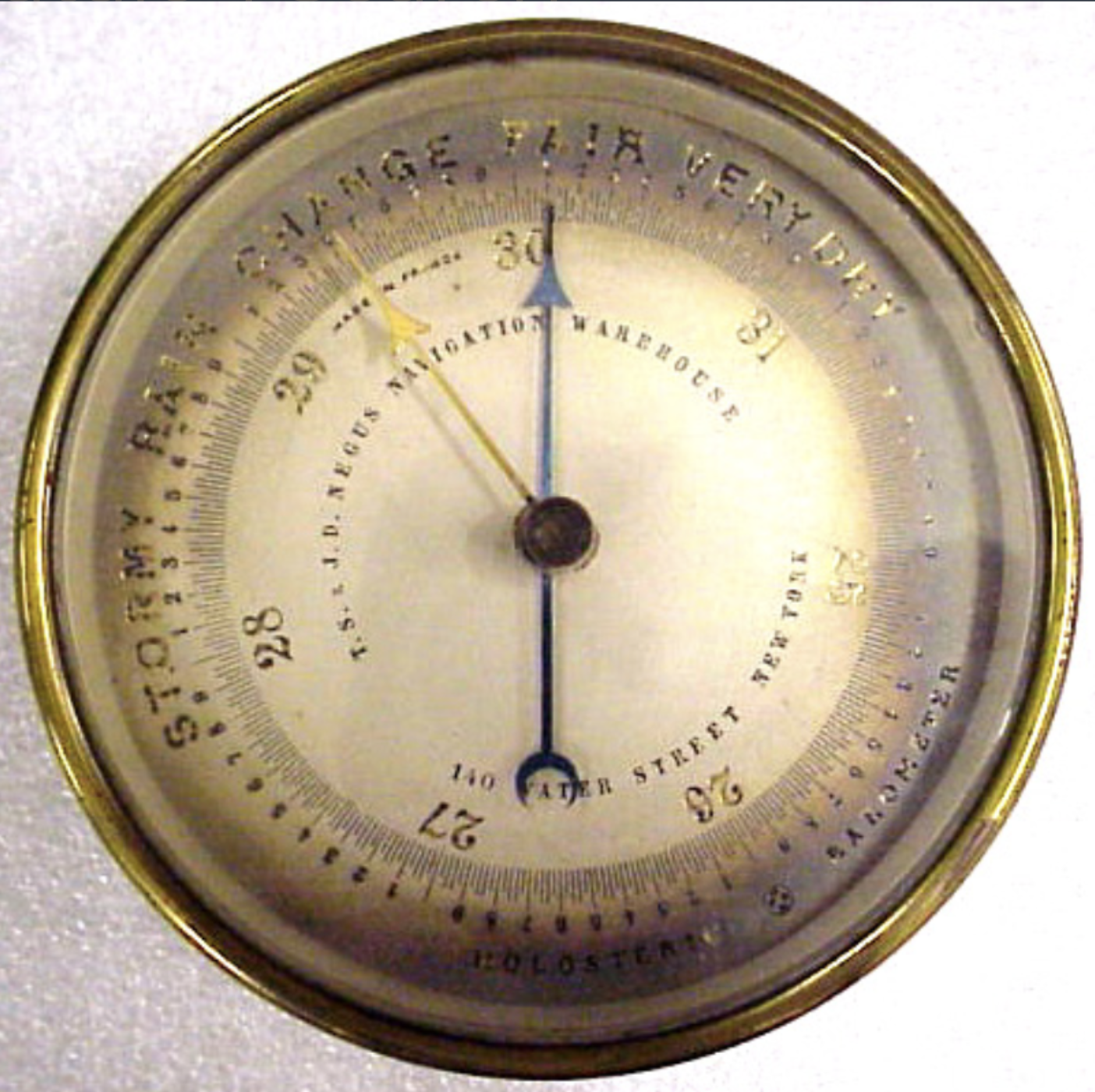 An old brass aneroid barometer, its dial marked stormy, rain, change, fair and very dry