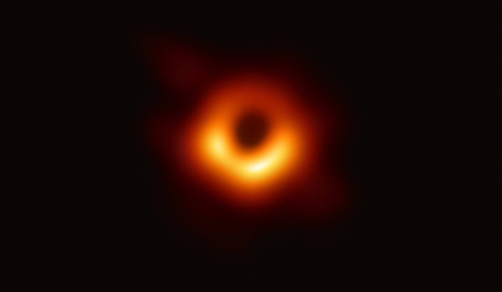 The first real image of a black hole (in galaxy M87), a dark centre ringed by glowing gas.