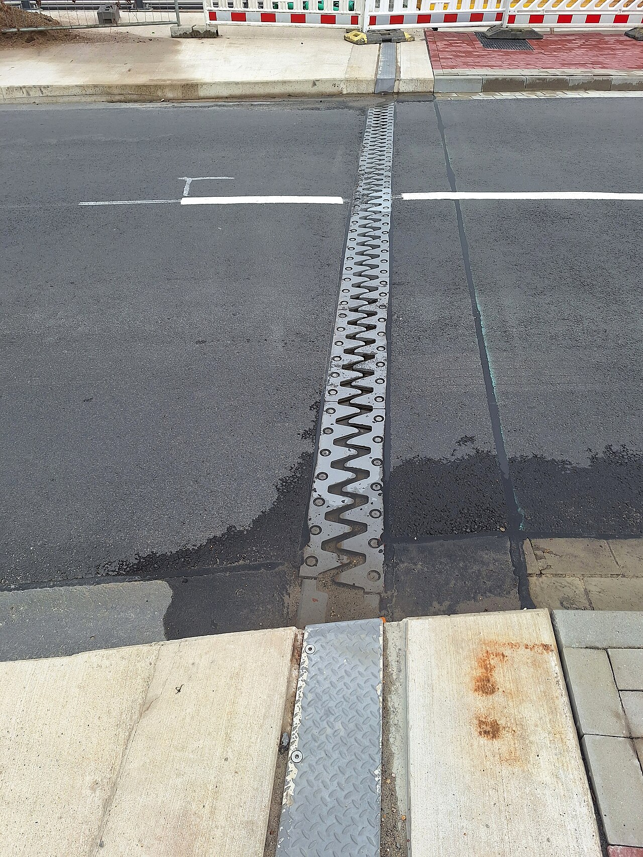 An expansion joint in a bridge, leaving a gap so the metal can expand on hot days.
