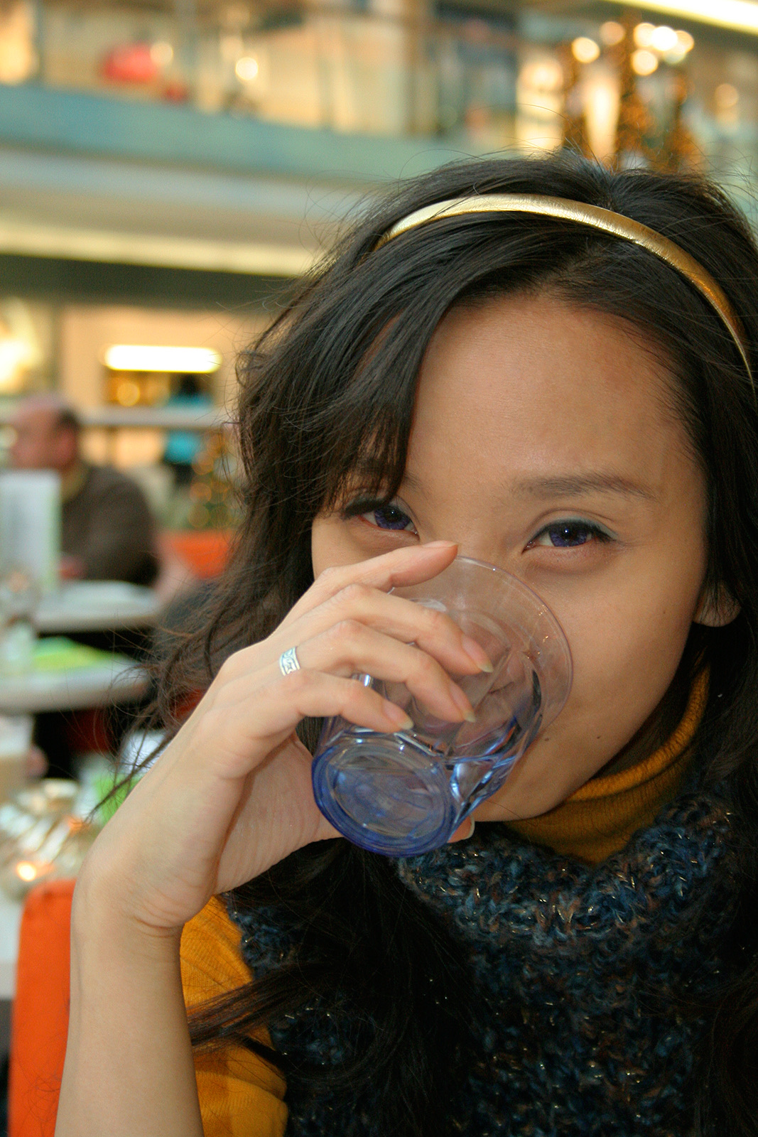 A young person drinking a glass of water