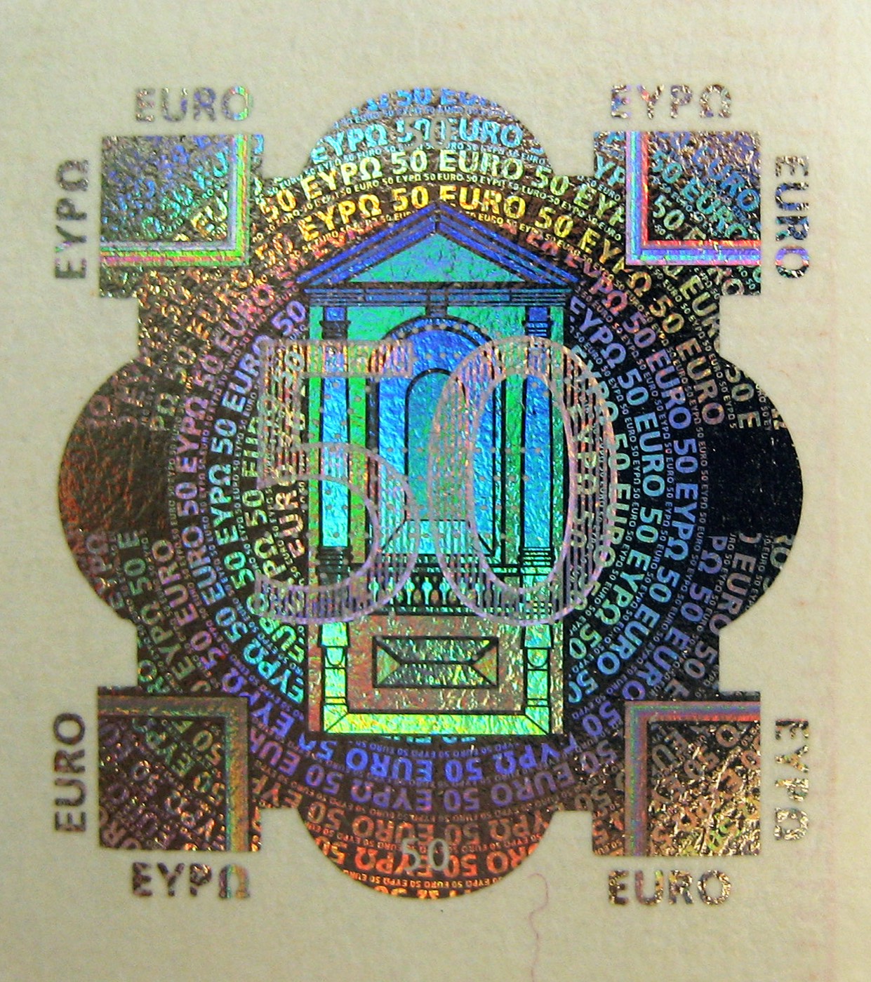 A close-up of the hologram patch on a fifty euro banknote, shimmering in green, blue and gold
