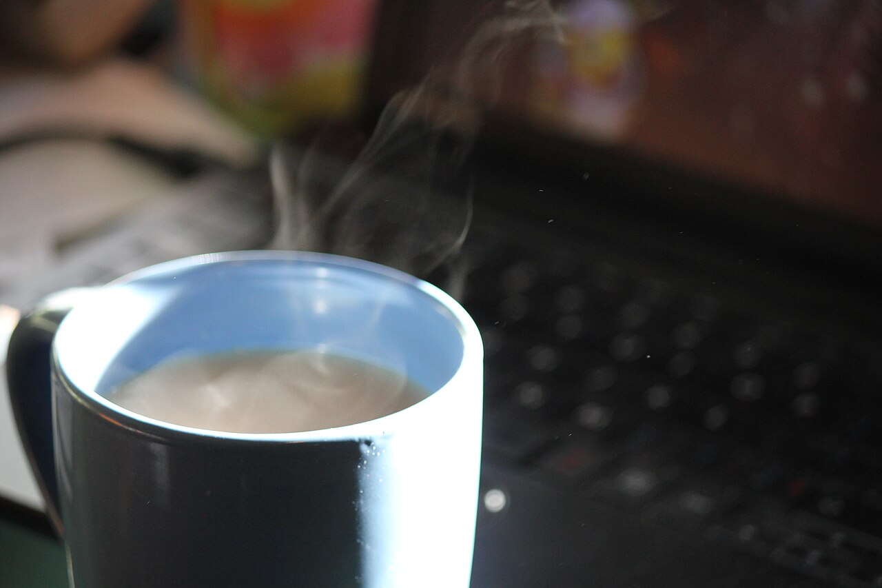 A steaming hot cup of tea, slowly losing its heat to the room.