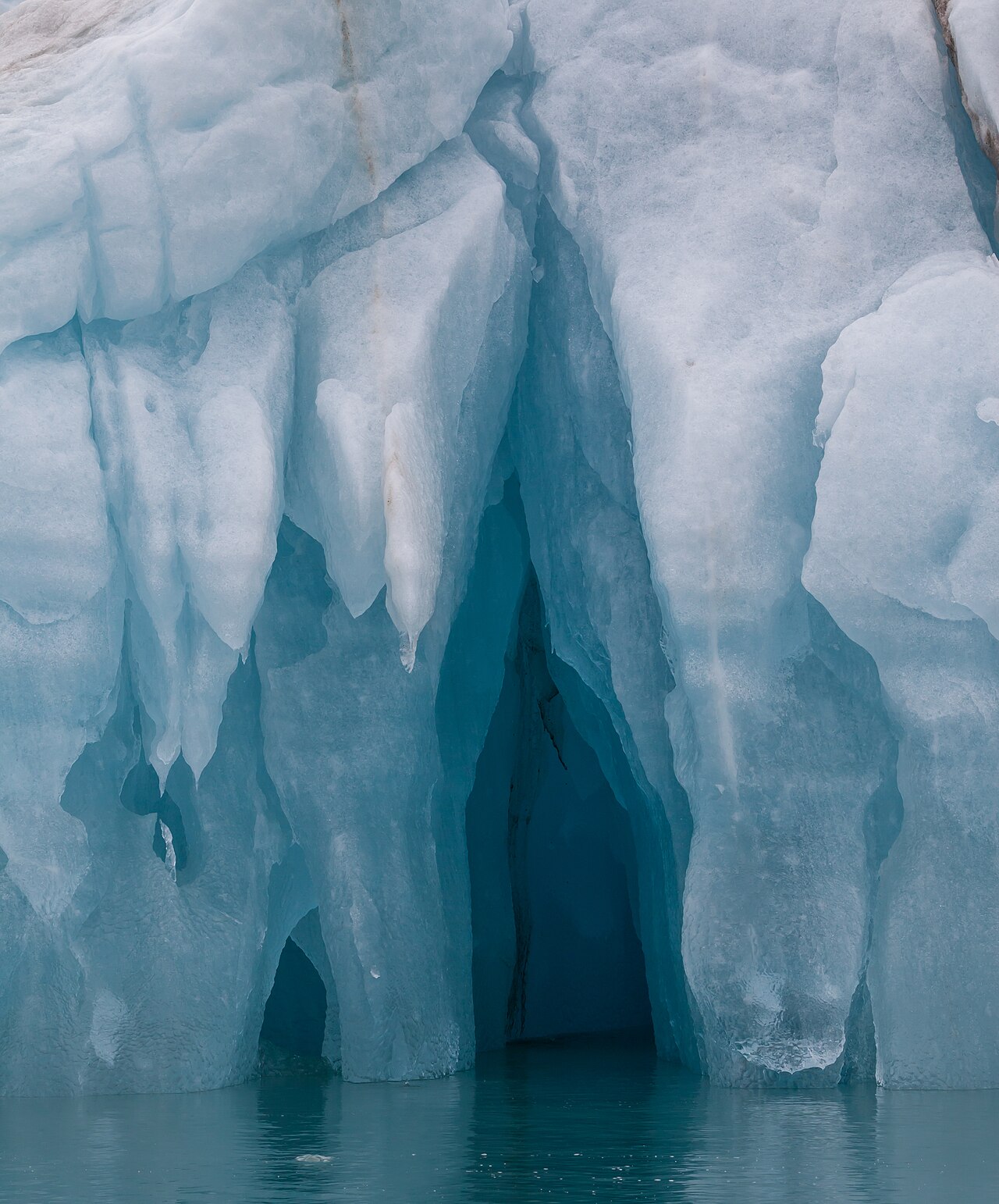 An iceberg photographed from below the waterline, showing how much sits underwater
