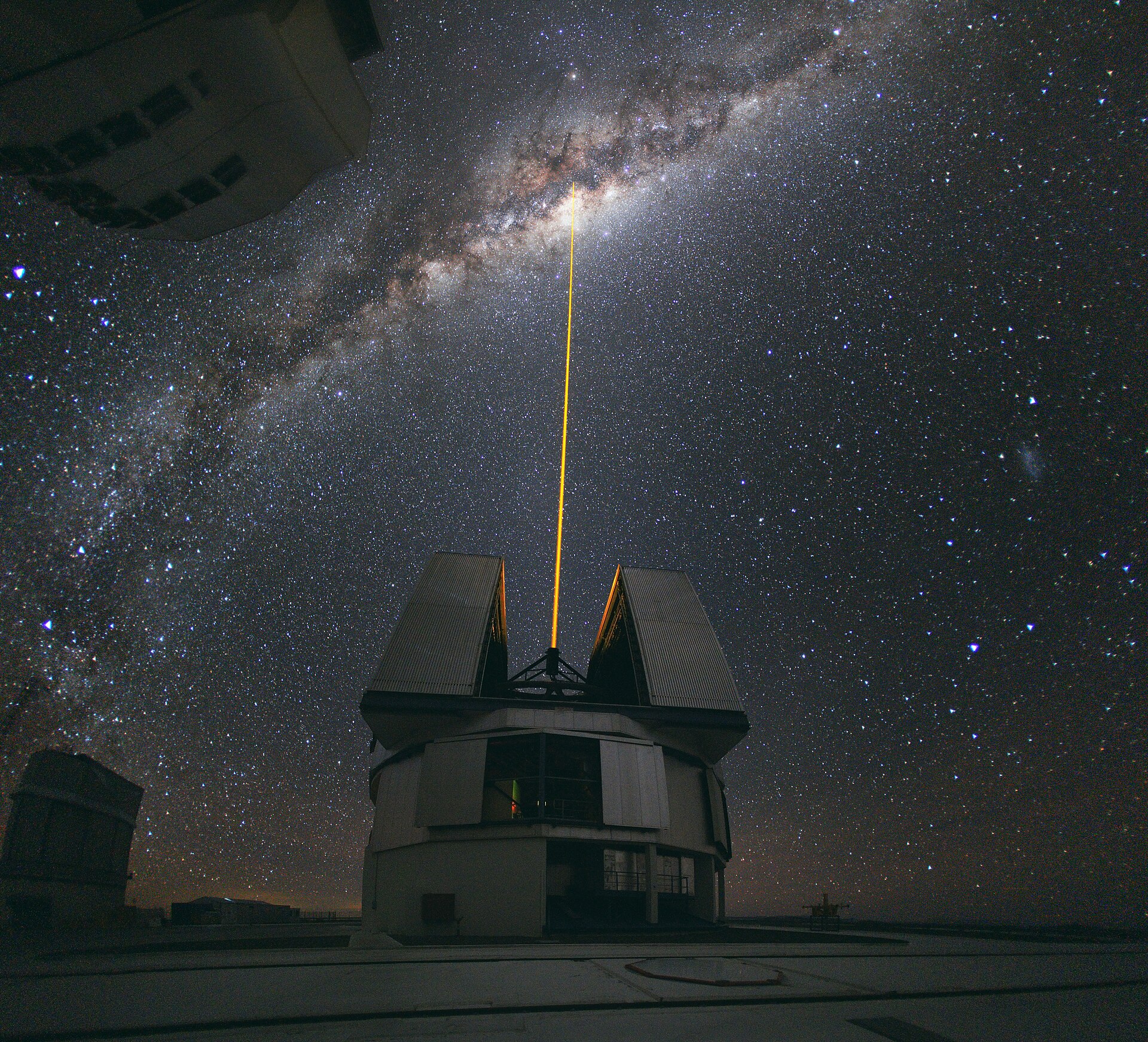 A laser beam shooting up from a telescope dome straight into the glowing heart of the Milky Way, travelling at the one speed nothing can beat
