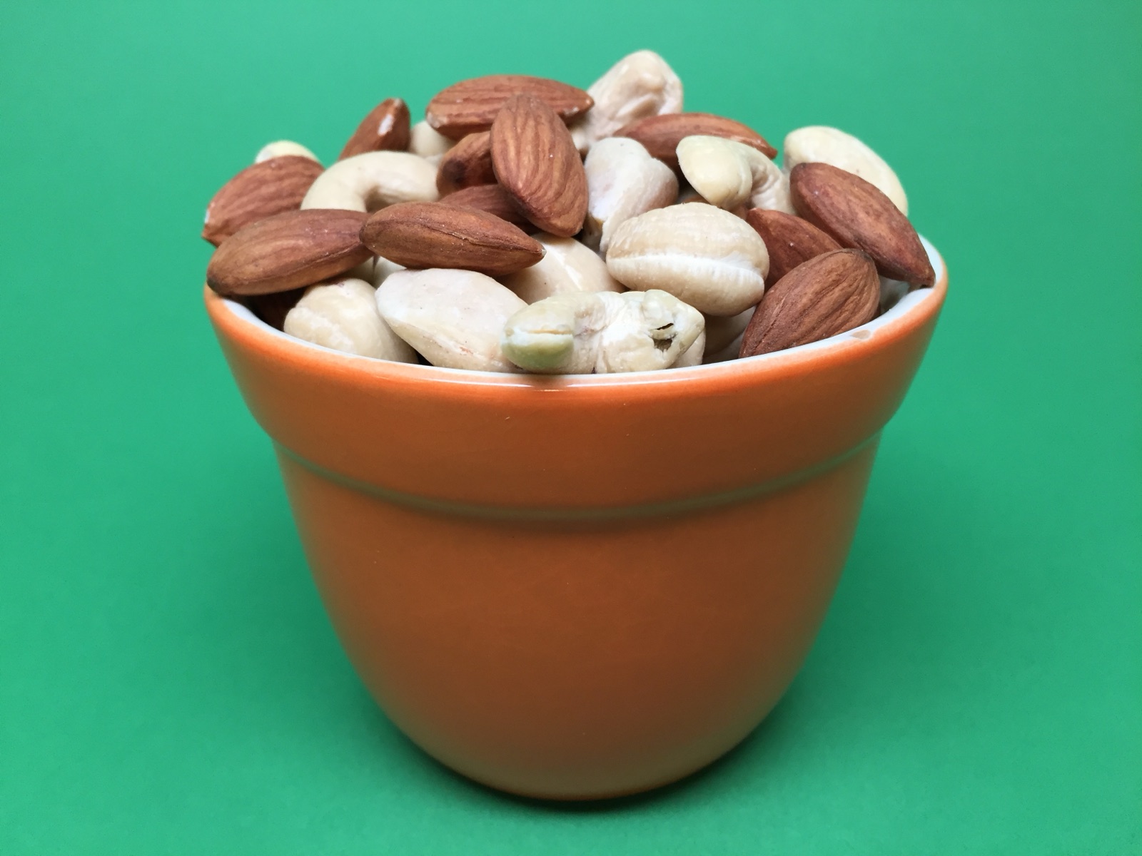 A bowl of mixed almonds and cashew nuts, both high-fat foods