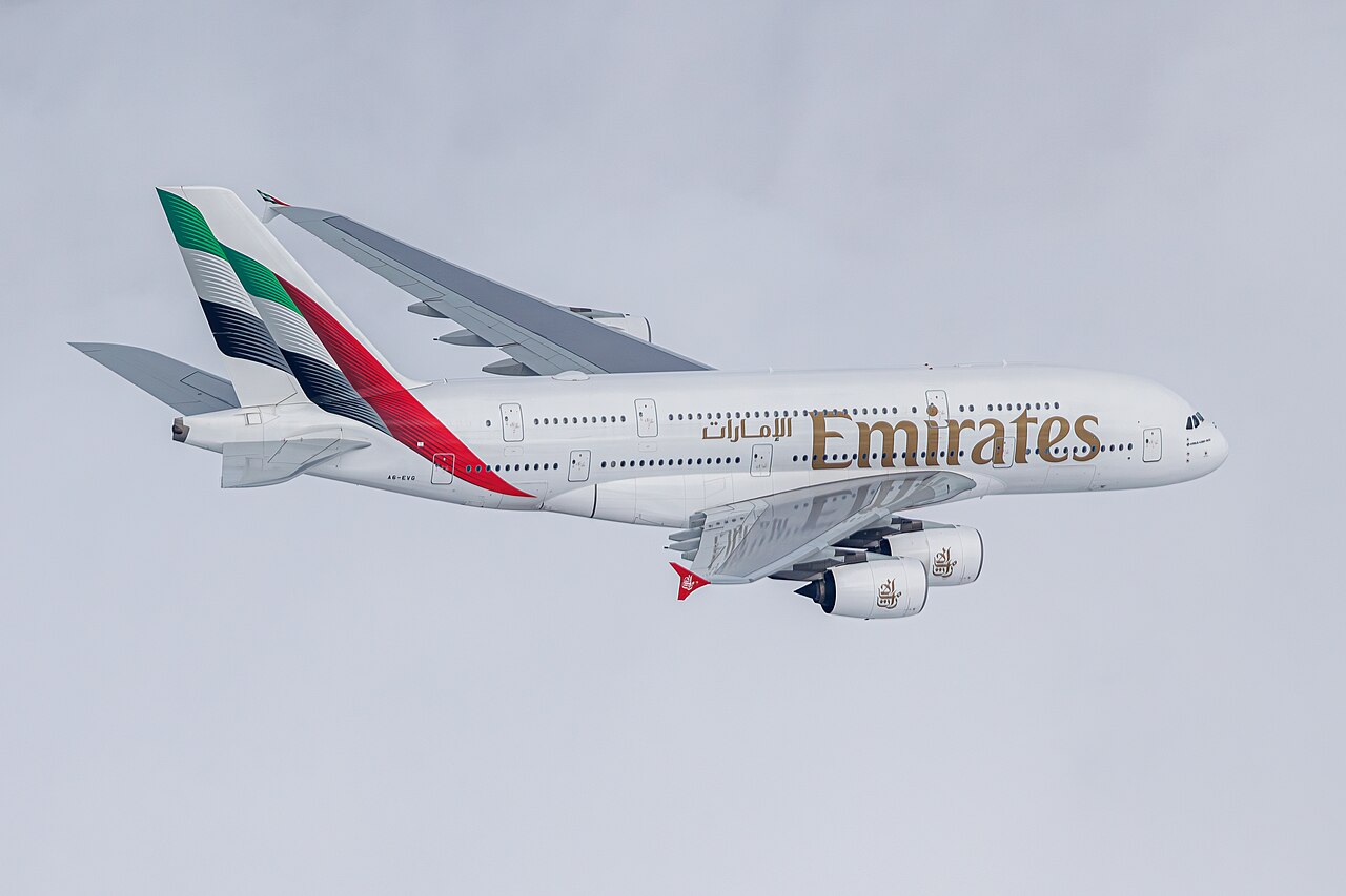 A huge airliner in flight, held up by the lift its wings make.