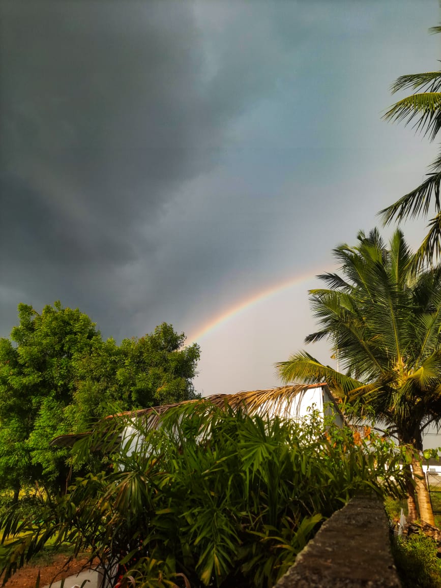 A bright rainbow arcing across the sky