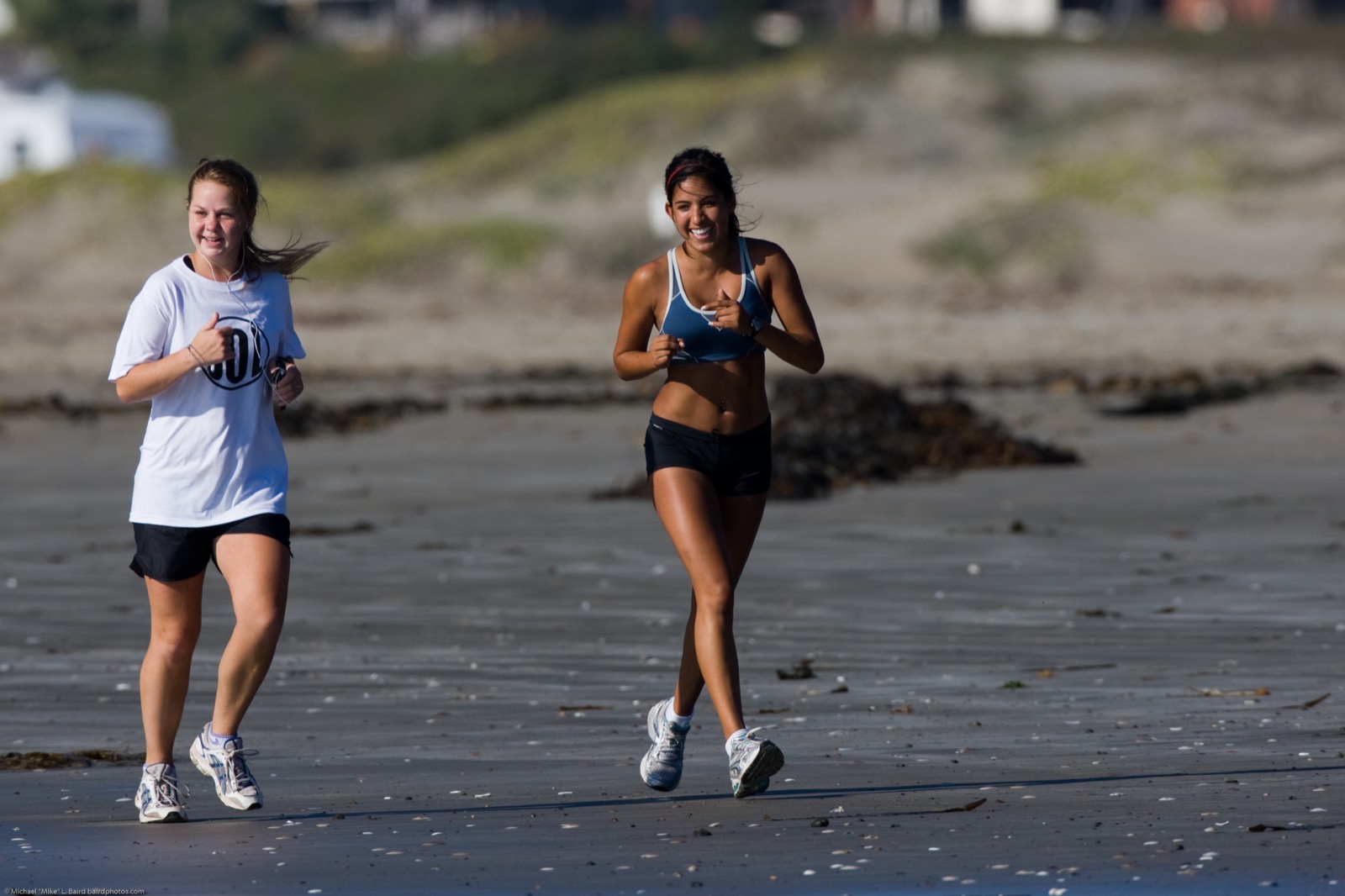 Two people jogging, breathing harder as they exercise.