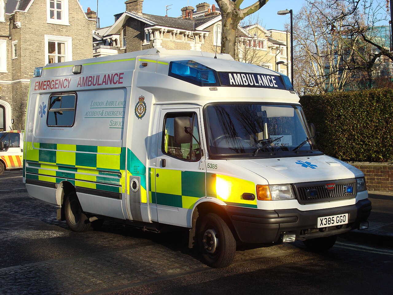 An ambulance, its siren drops in pitch as it races past you.