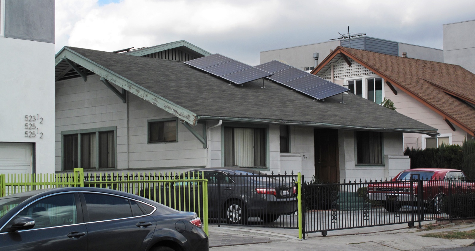 Solar panels mounted on the roof of a house, catching the daylight.