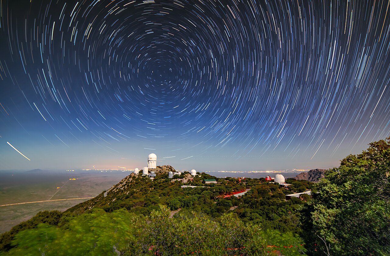 Long-exposure star trails circling the sky, caused by Earth's rotation