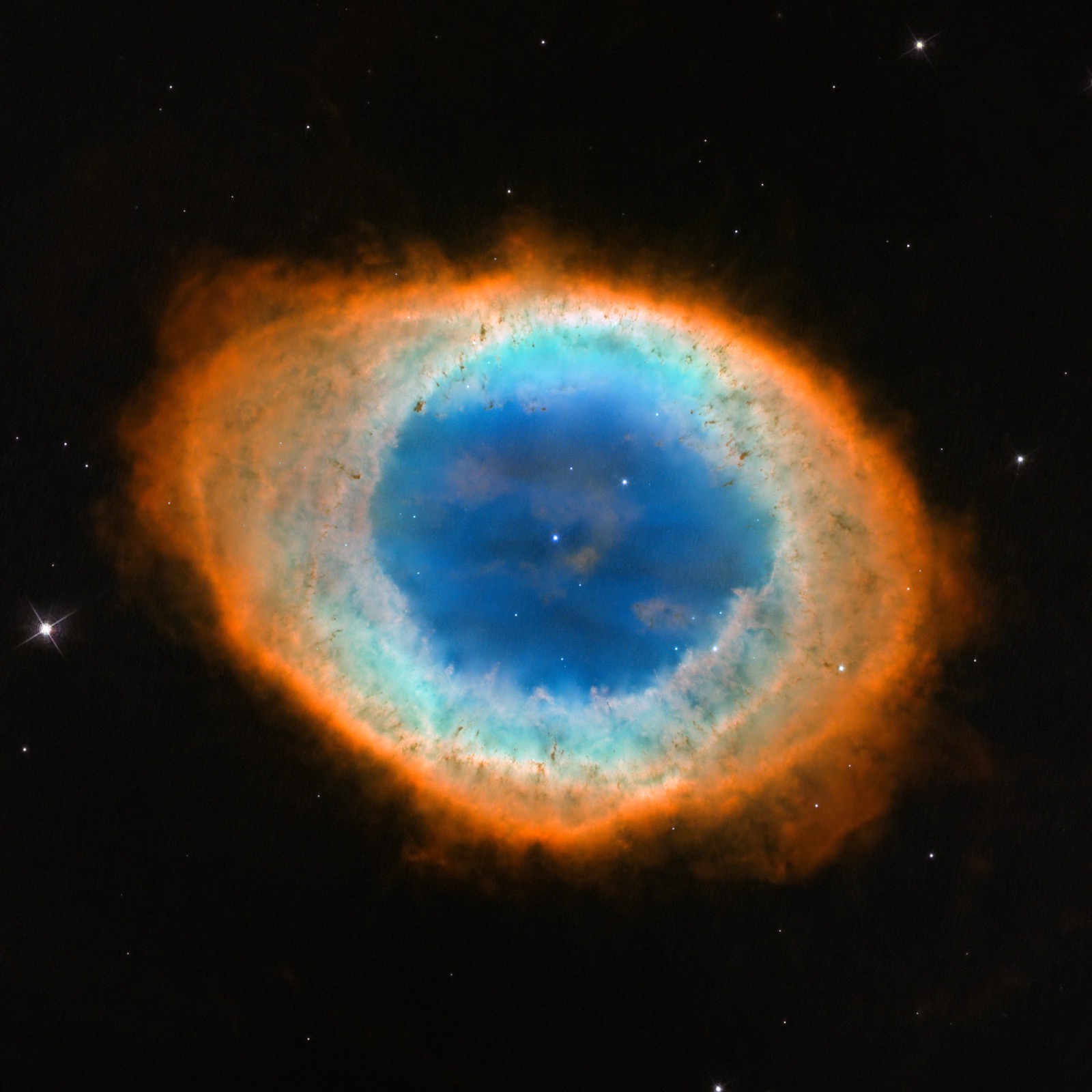 The Ring Nebula, the glowing shell of gas puffed off by a dying Sun-like star.