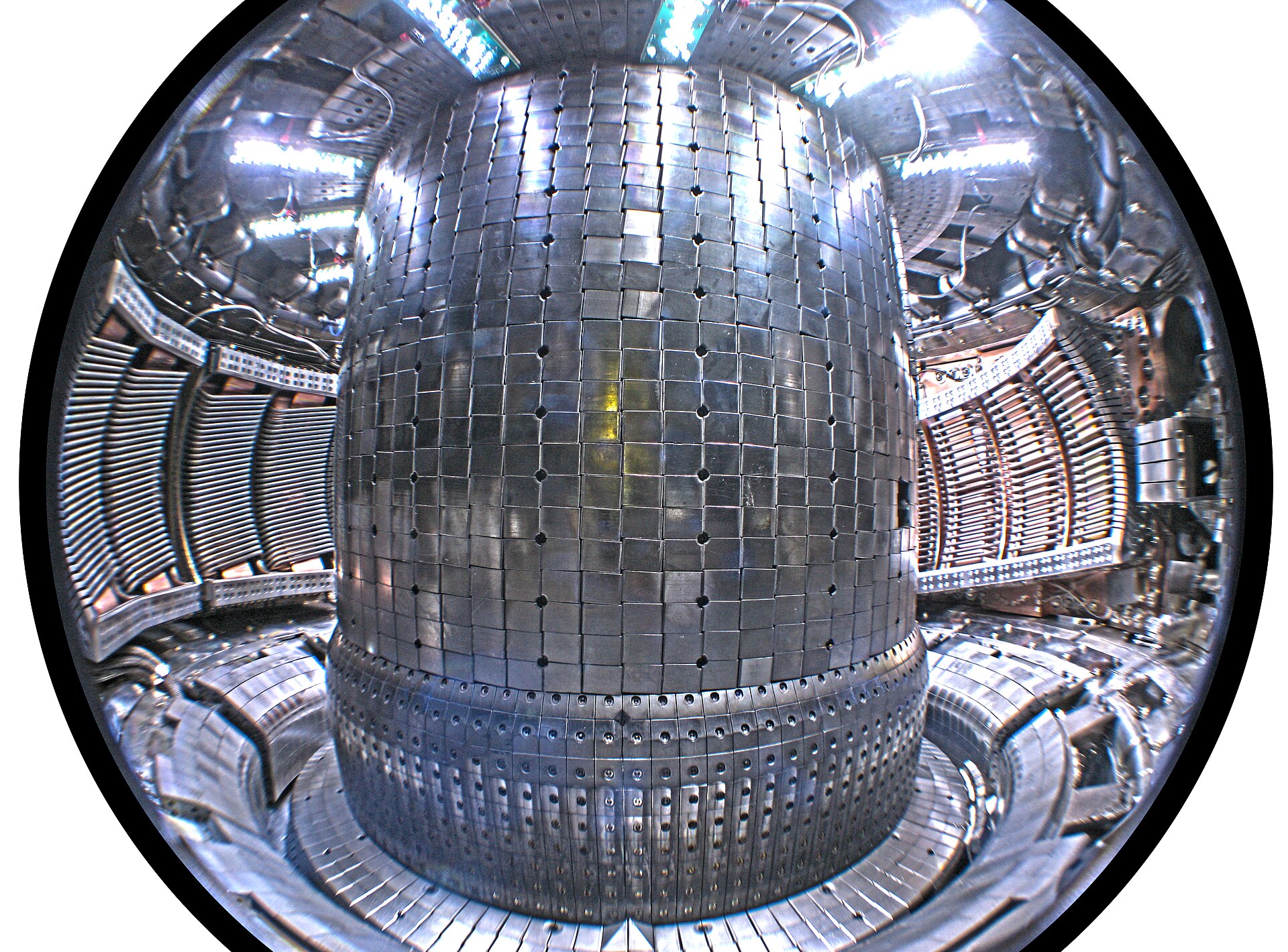 The inside of a fusion machine, a gleaming metal doughnut lined with thousands of tiles, built to hold gas hotter than the heart of the Sun