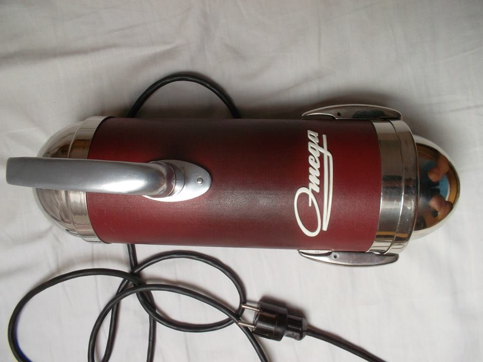 A vacuum cleaner, it lowers the pressure inside so outside air rushes in, carrying dust.