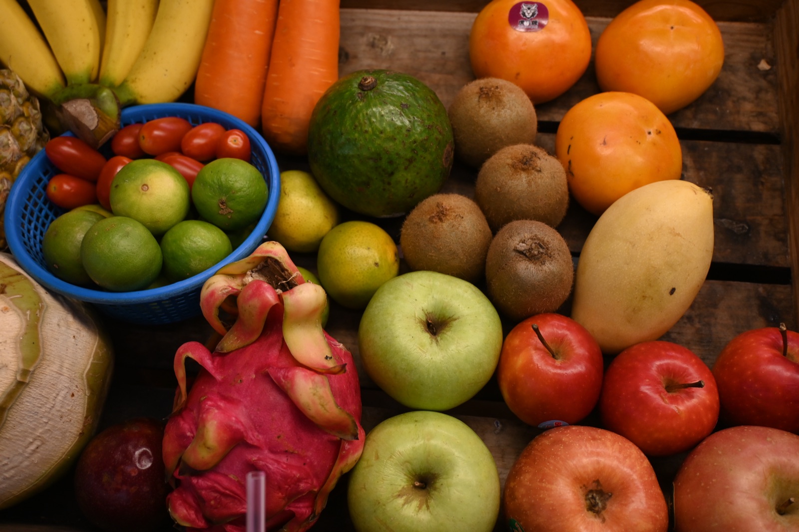 A colourful assortment of fresh fruits and vegetables arranged on a wooden crate