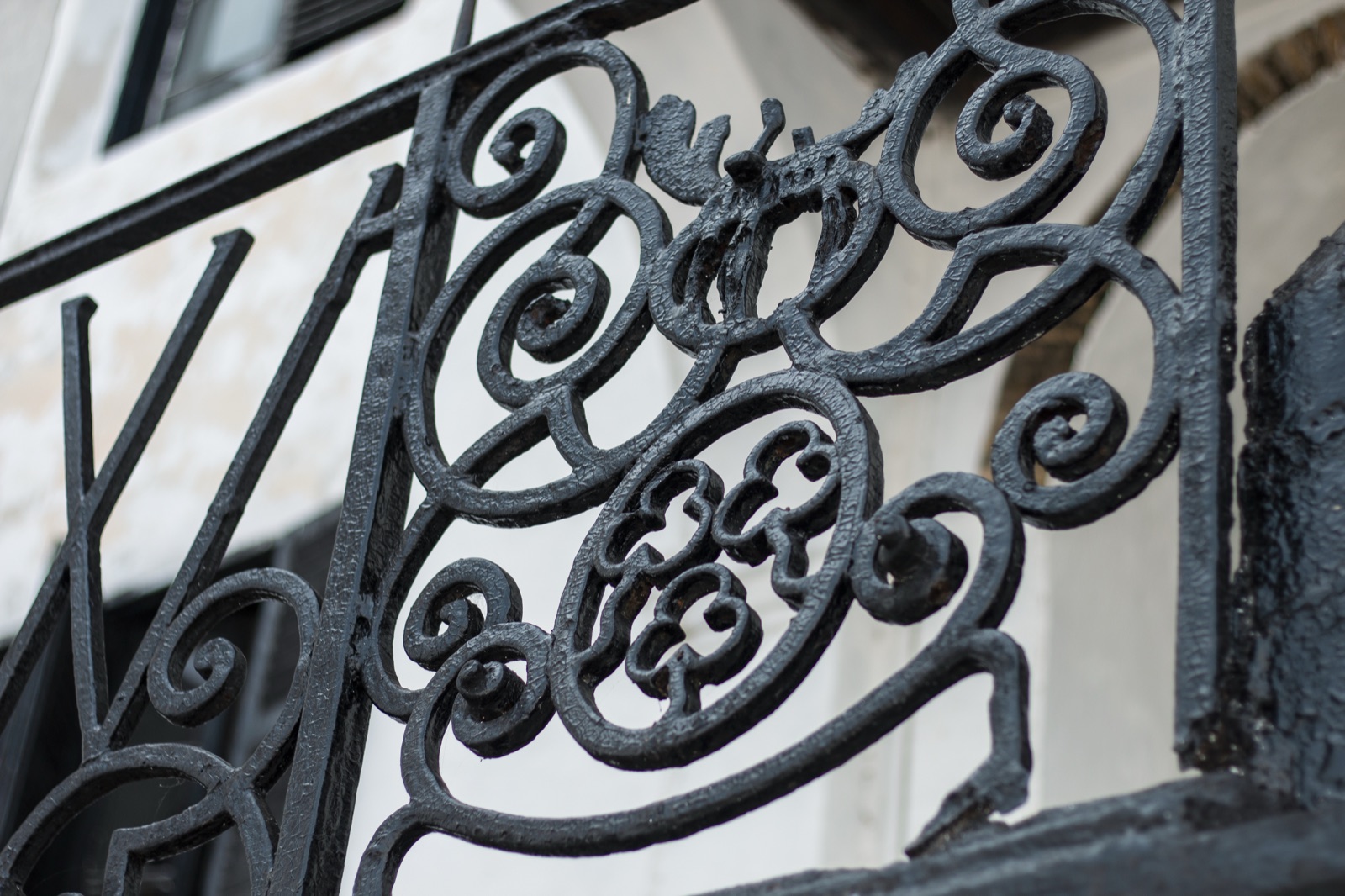 Black wrought-iron scrollwork, metal bent and curled into decorative curves